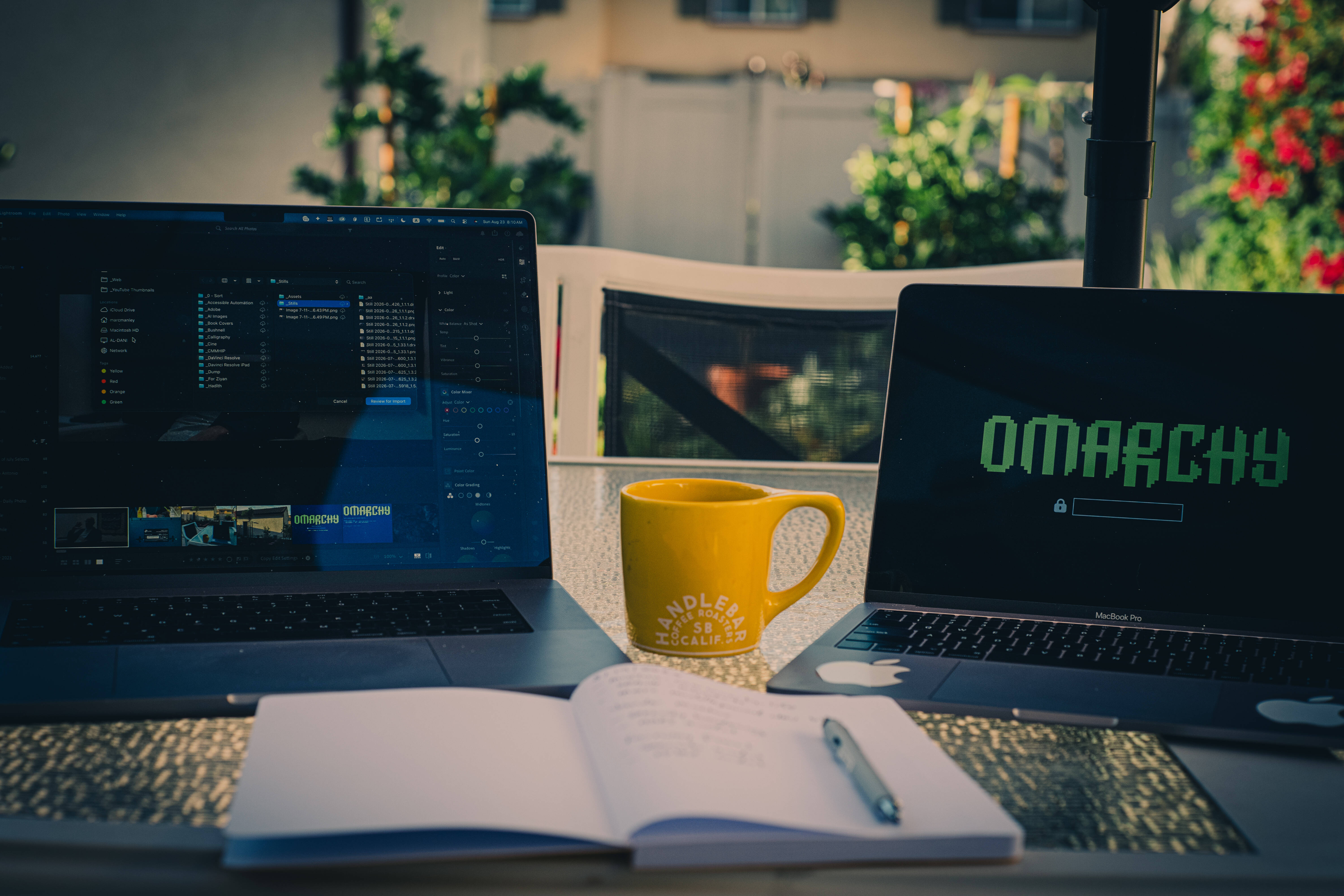 Working outside with Lightroom open next to a laptop booting into Omarchy